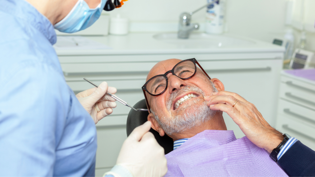 Elderly man showing significant tooth pain during a dental checkup at Professional Dental, Utah.