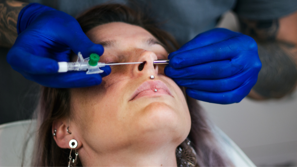 Medical professional wearing blue gloves performing a nasal procedure on a woman in a clinical setting in Utah
